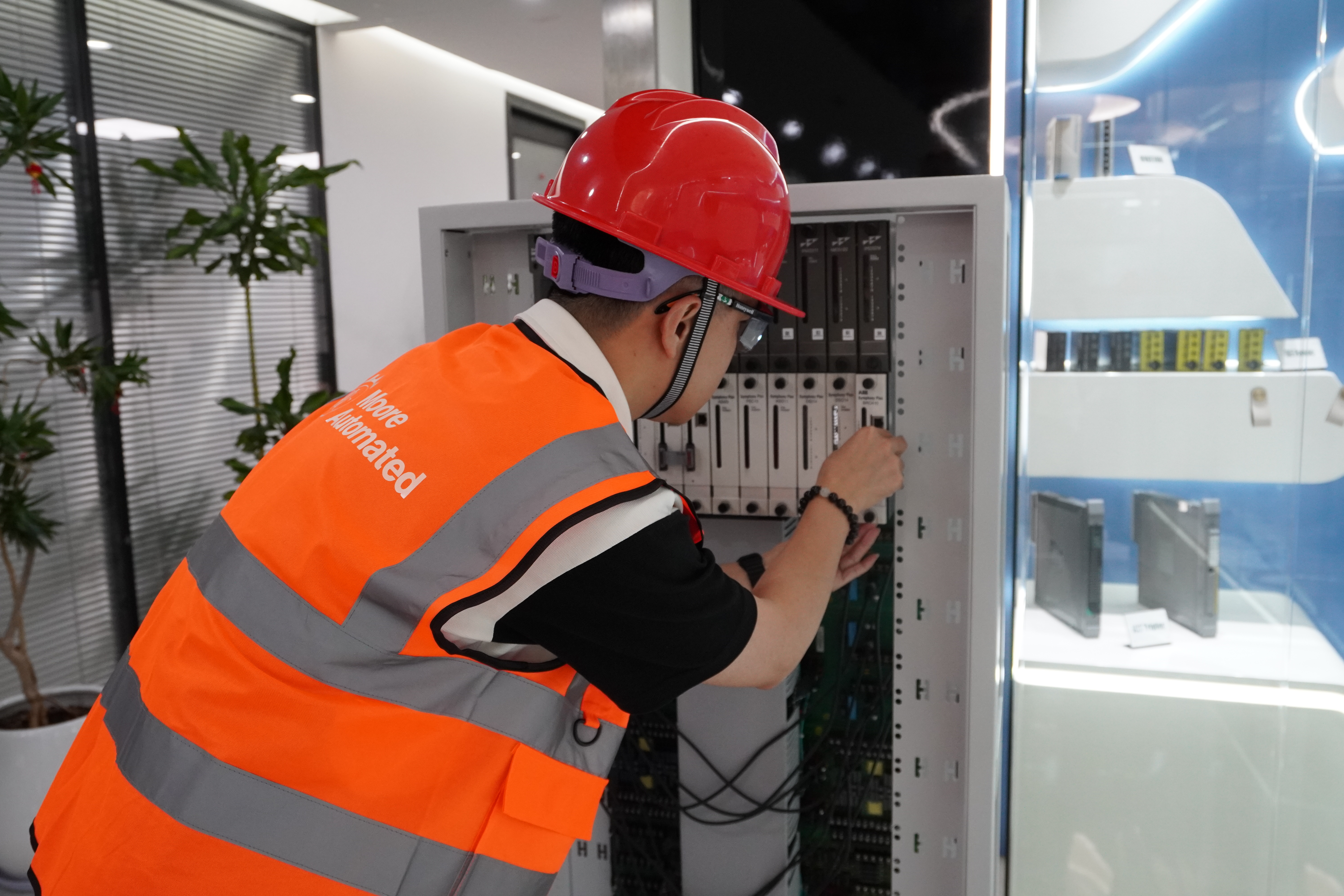 Technical specialist reviewing an industrial control cabinet installation