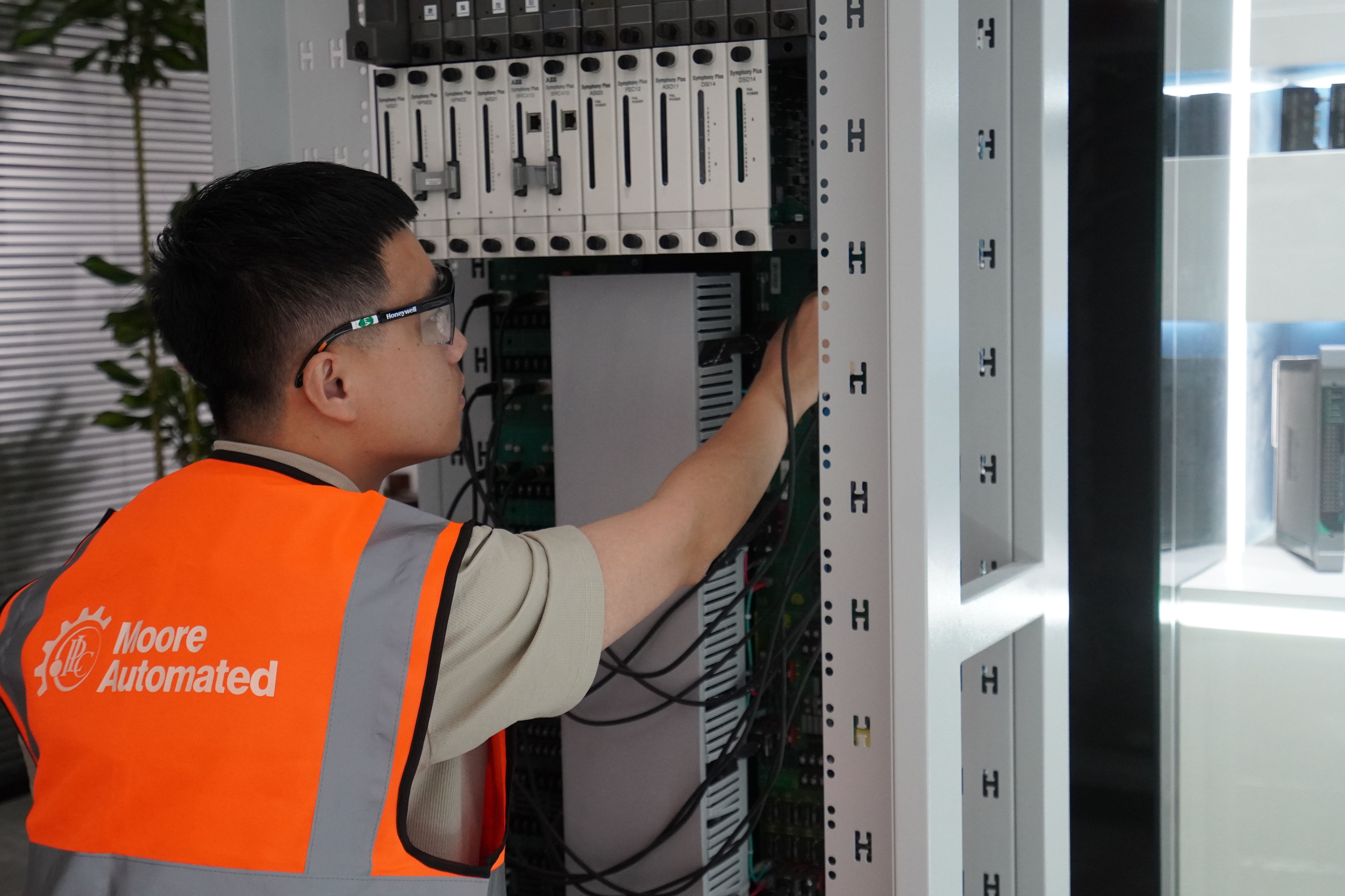 Automation engineer reviewing installed control cabinet equipment