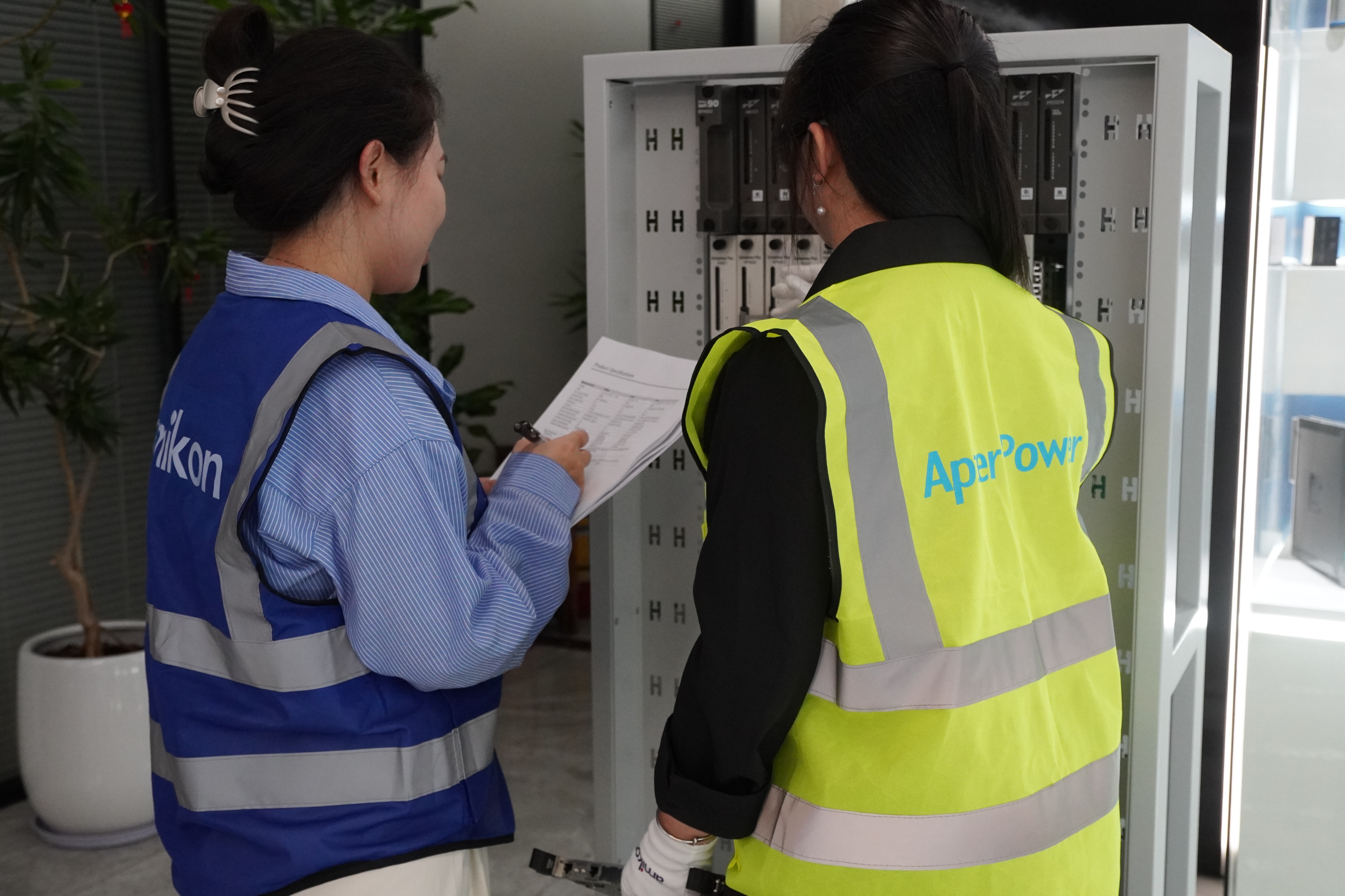 Technical specialists reviewing an automation cabinet