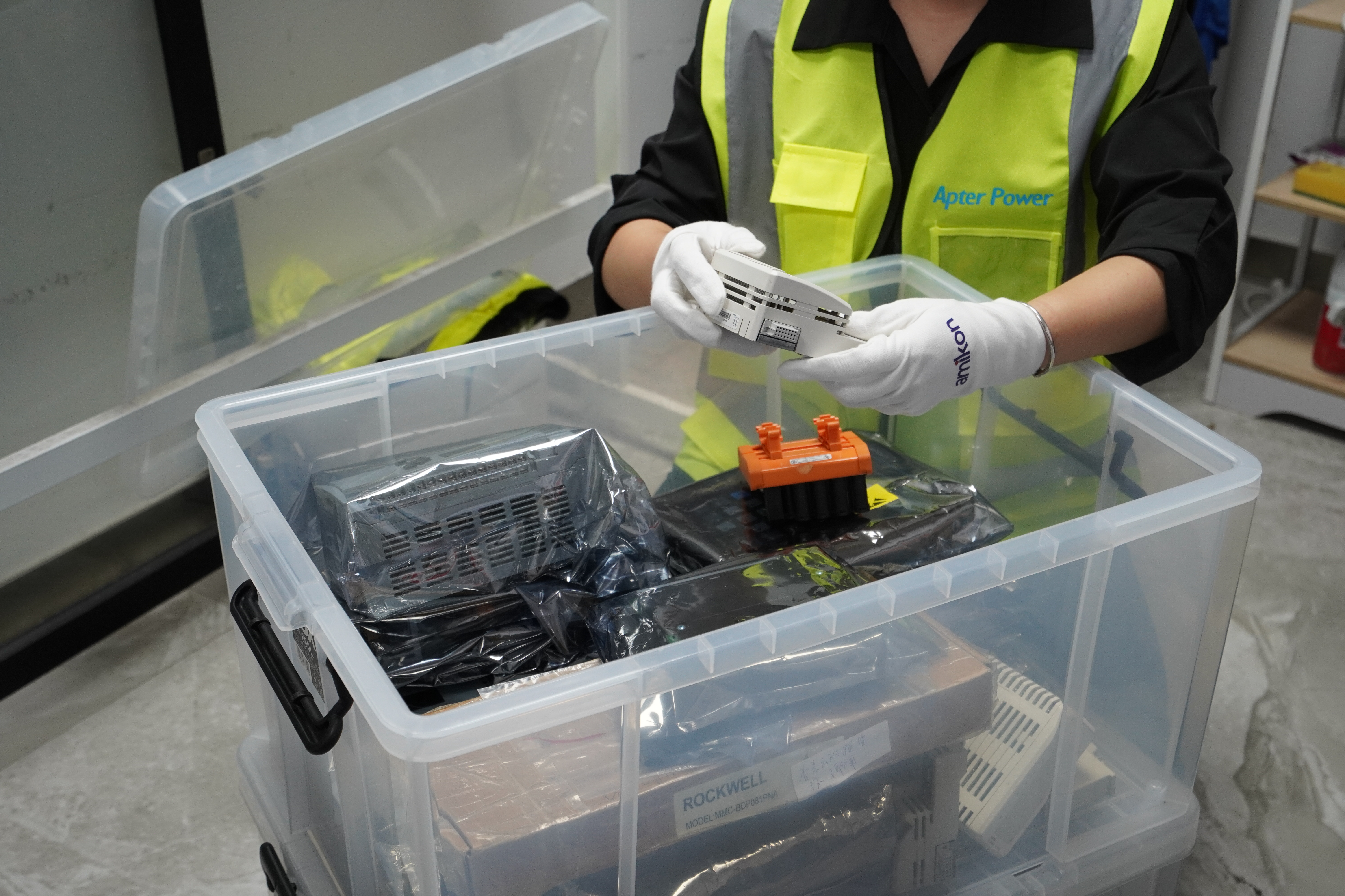 Quality inspector preparing automation parts for protective packing