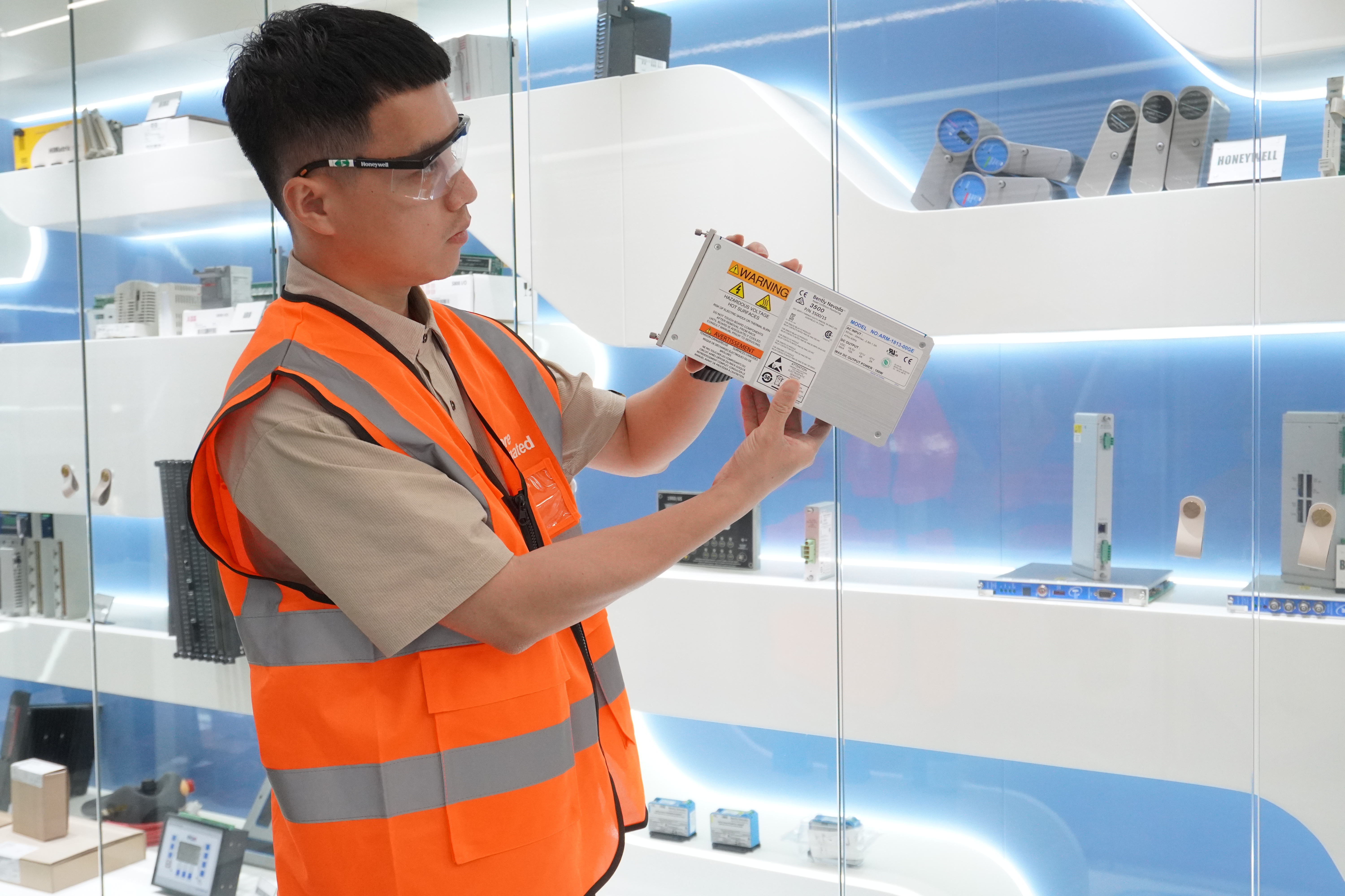 Stockoems technician checking an industrial module nameplate and condition